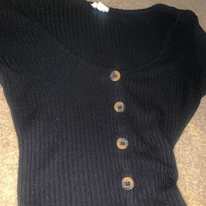 long sleeved black shirt , with brown button ups